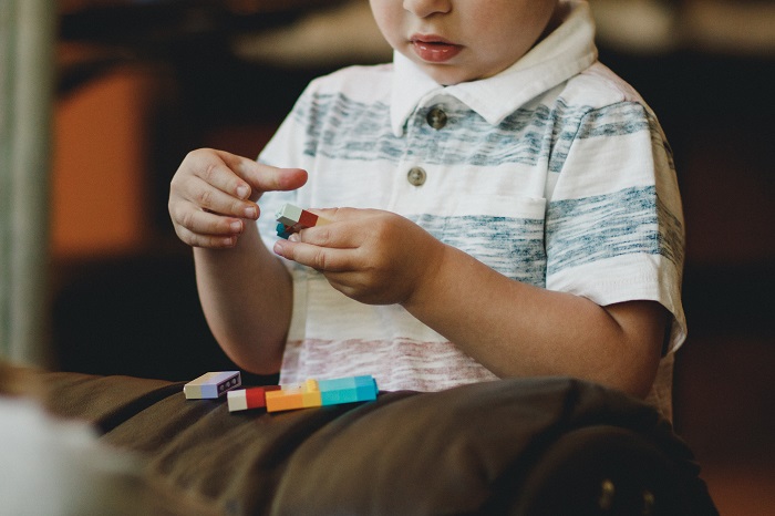 Autistic child playing with Lego toys