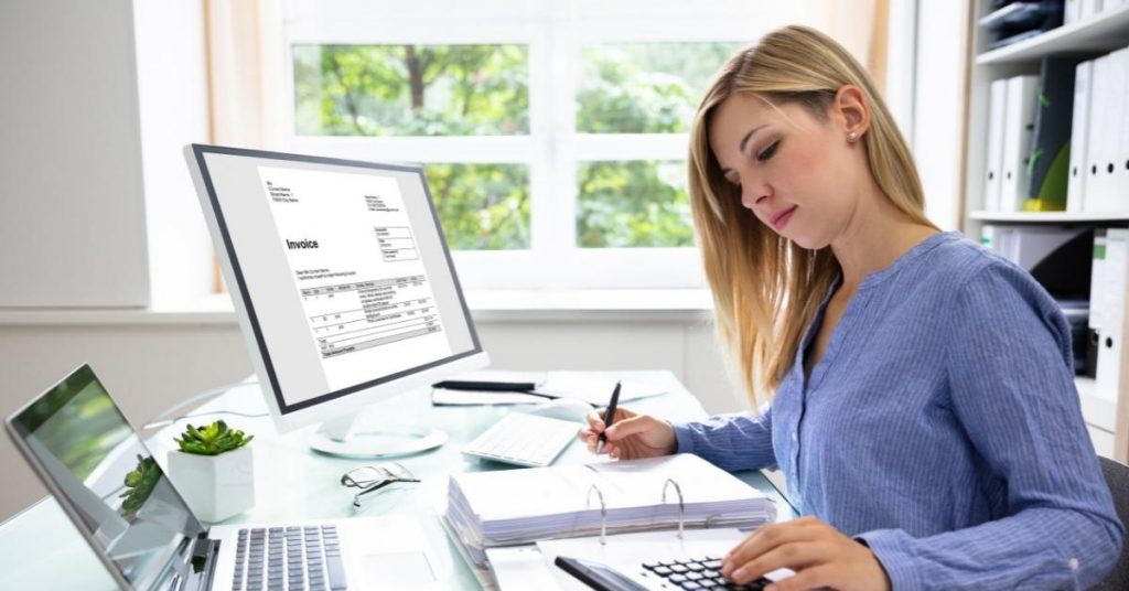 Young woman in an office working on invoices
