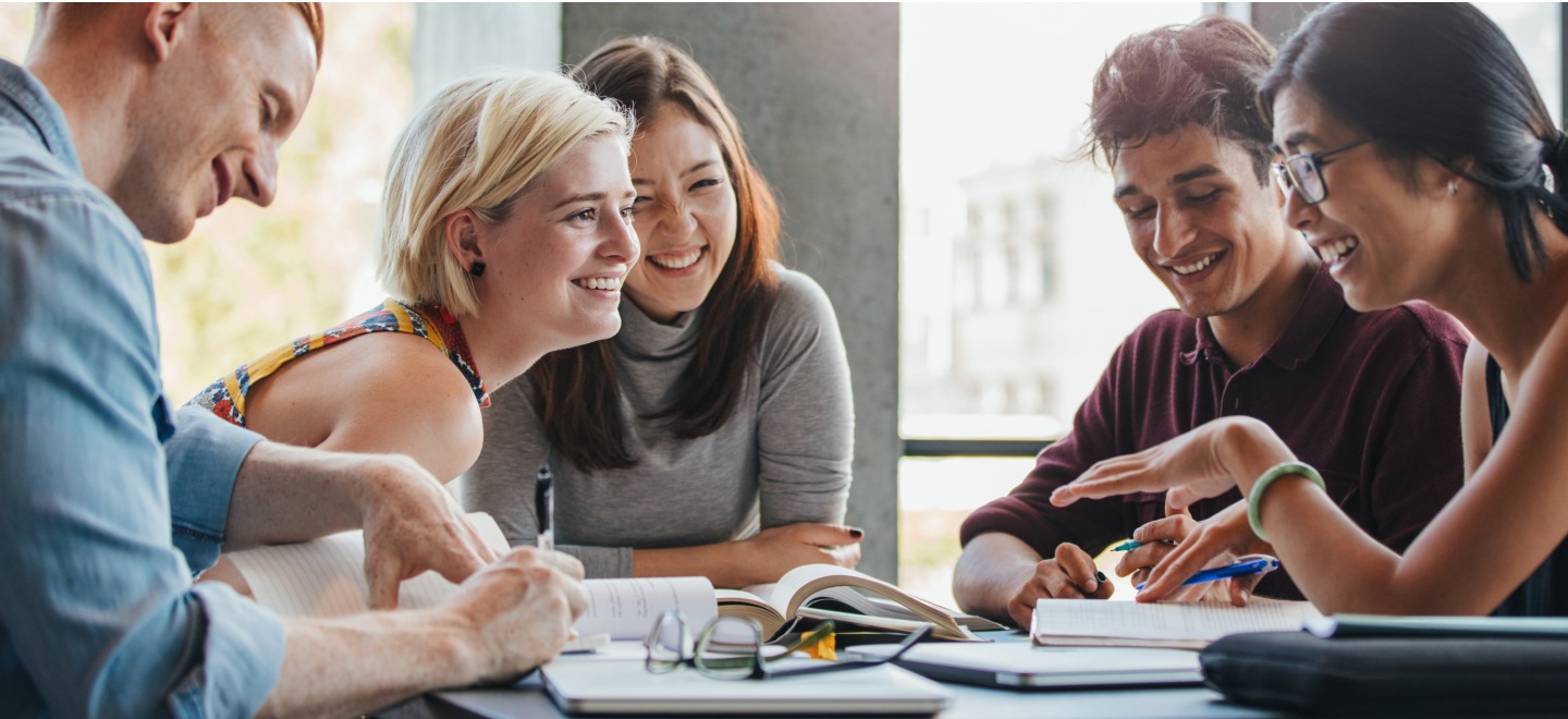 Students studying together while smiling