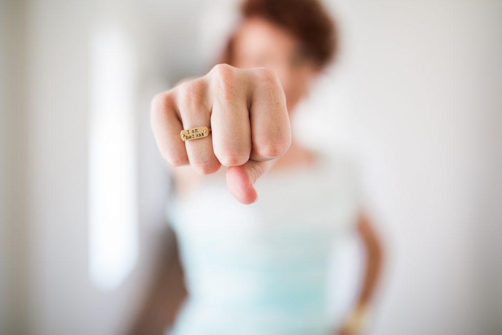 Woman with I am bad ass ring