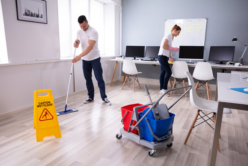 People cleaning a workspace