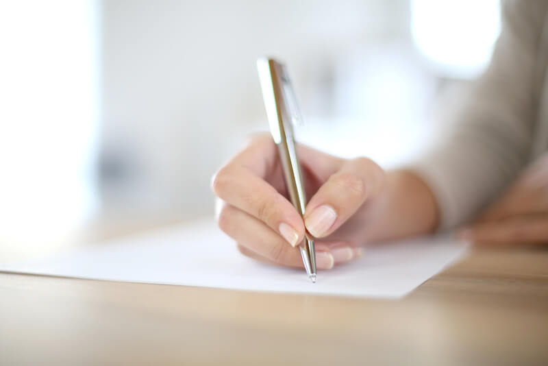 the right hand of a female taking notes