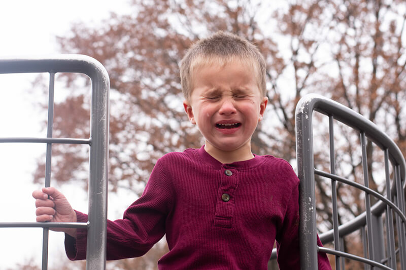 little boy crying at a playground a single tear rolls down his cheek t20 kRKGpp