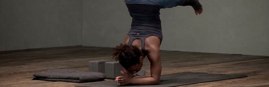 Woman performing yoga handstand