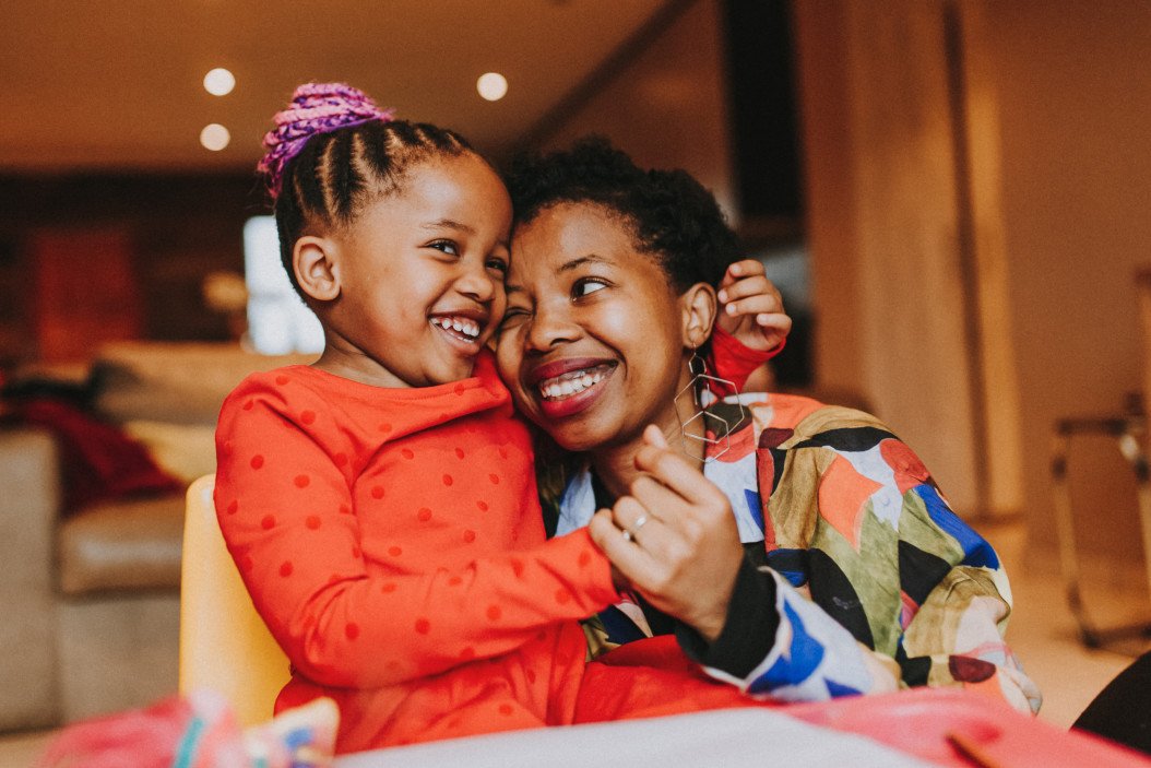 Mother and daughter hugging and laughing