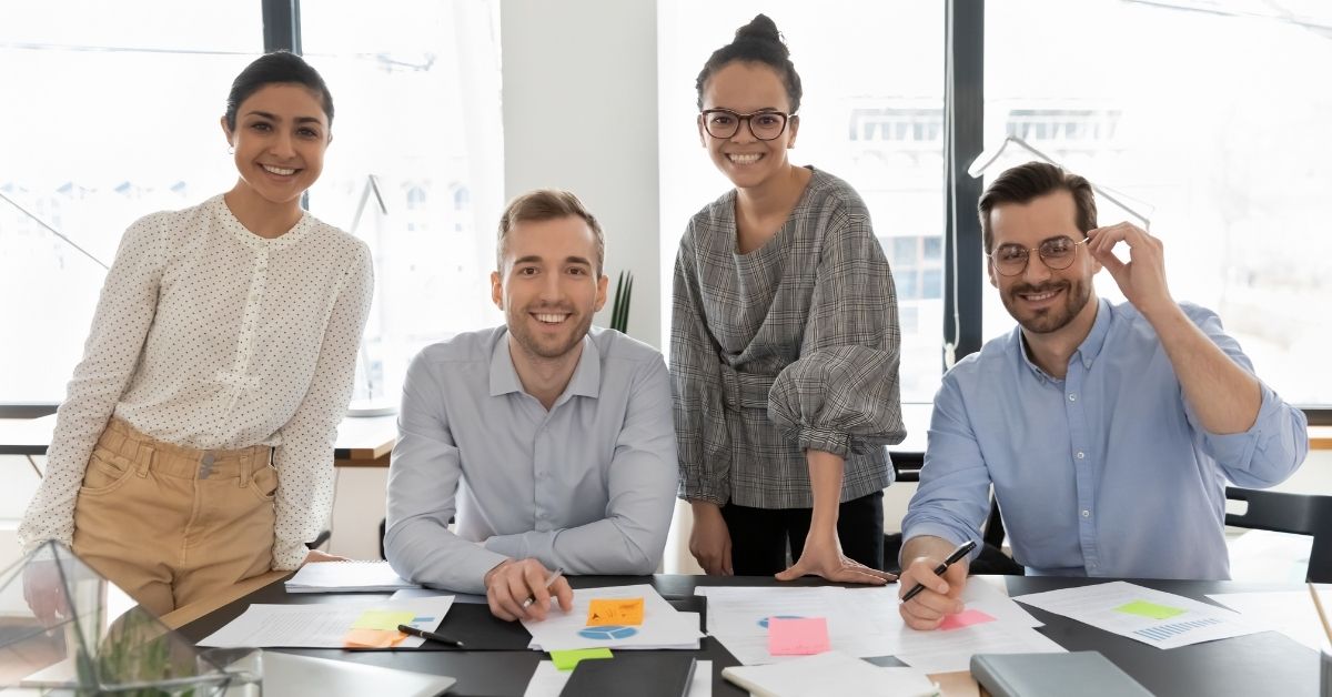 Employees posing for a picture in the office