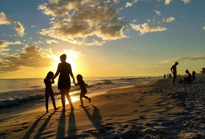 People at the beach during the sunset