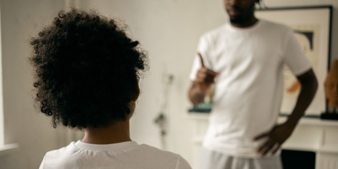 African American father scolding son