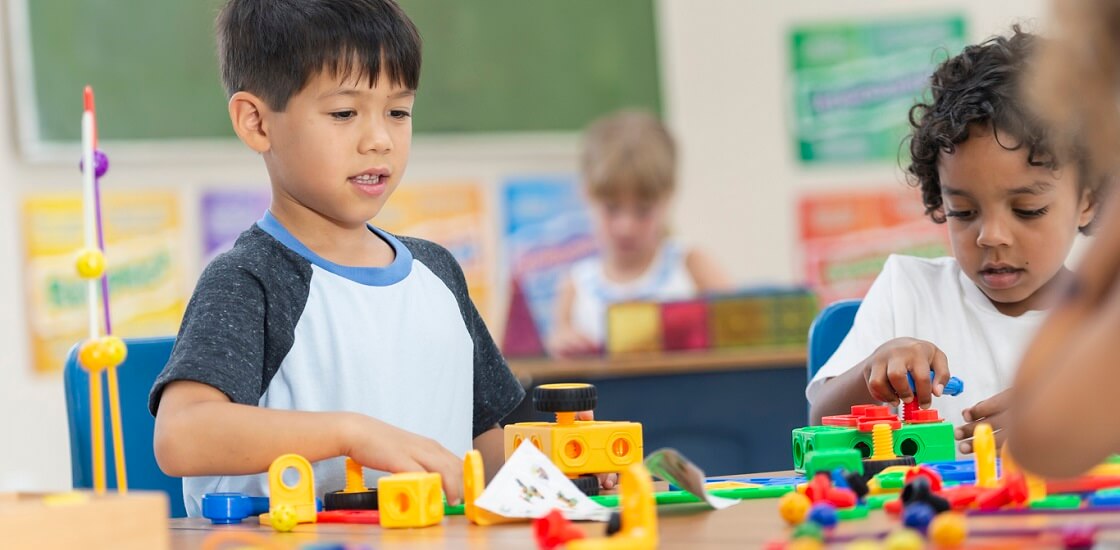 Children in class working on an activity with blocks