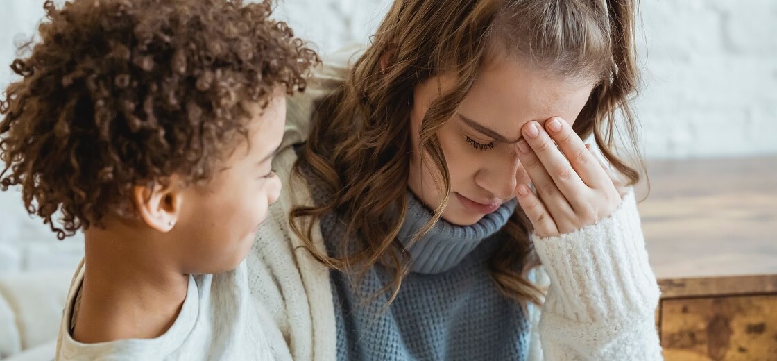 African American boy comforting upset mother