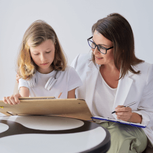 Doctor helping girl with psycho pedagogical intervention