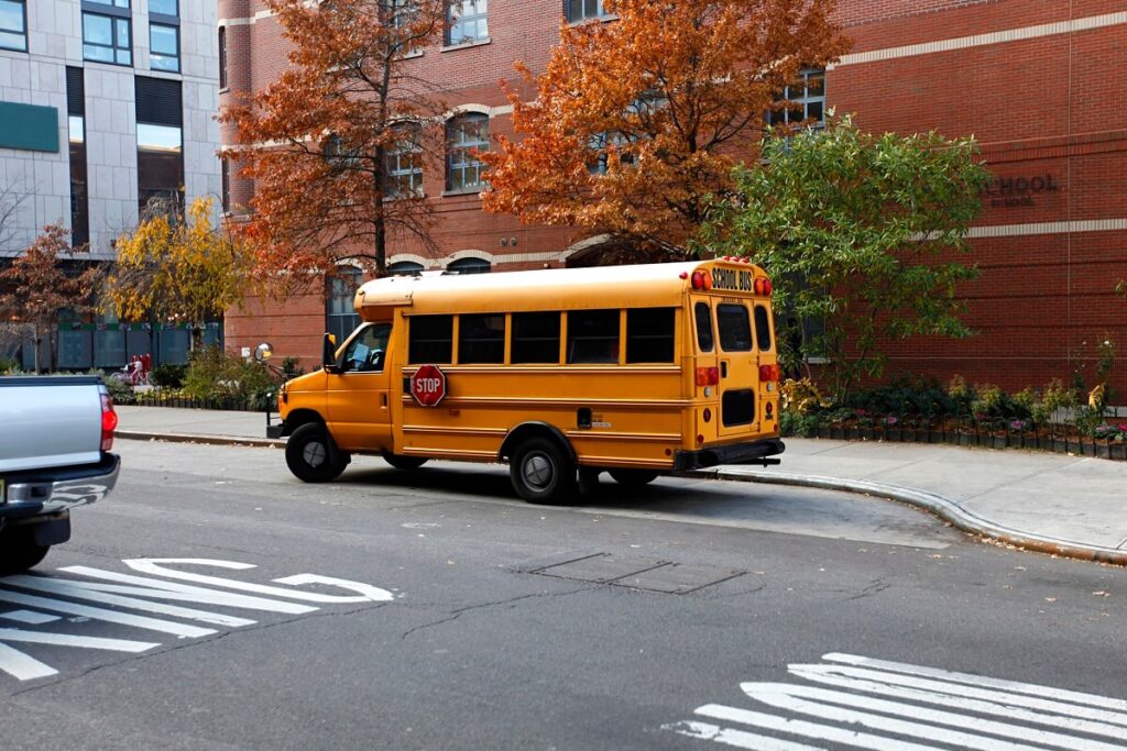 Yellow public school bus on the road in New York City