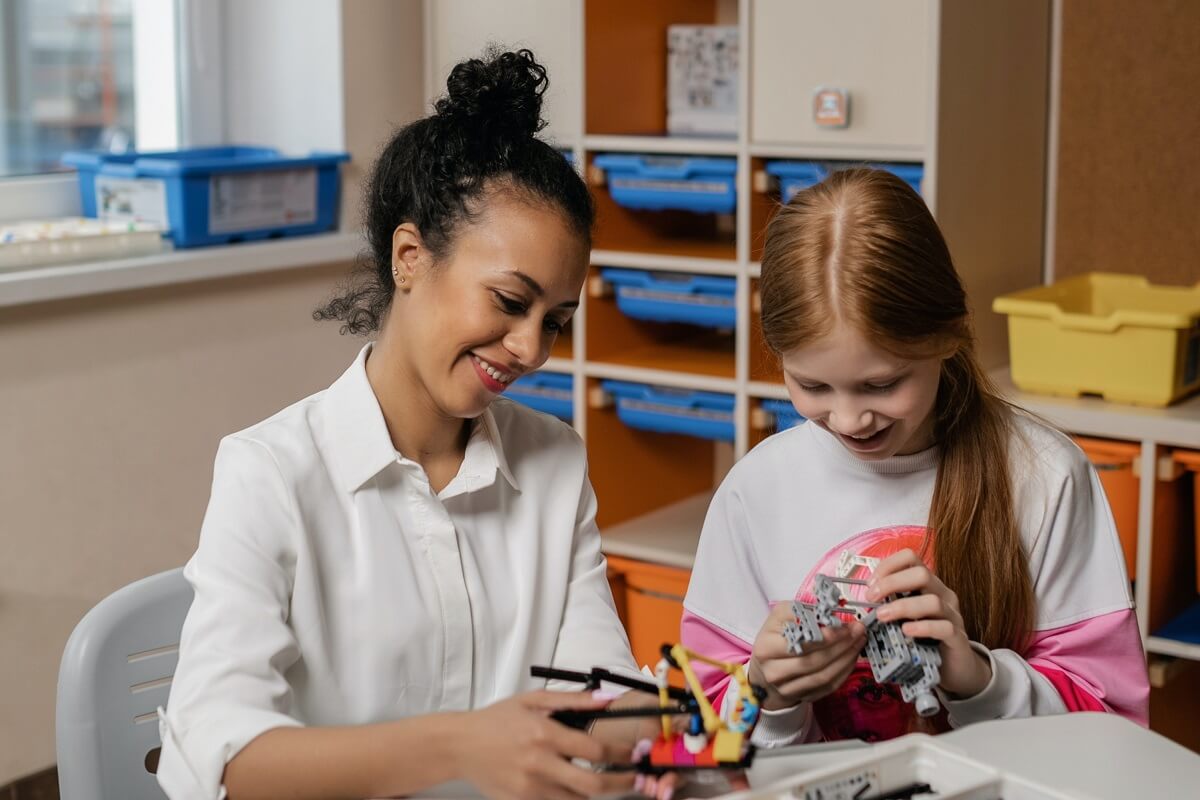 ABA provider with student using connecting toys