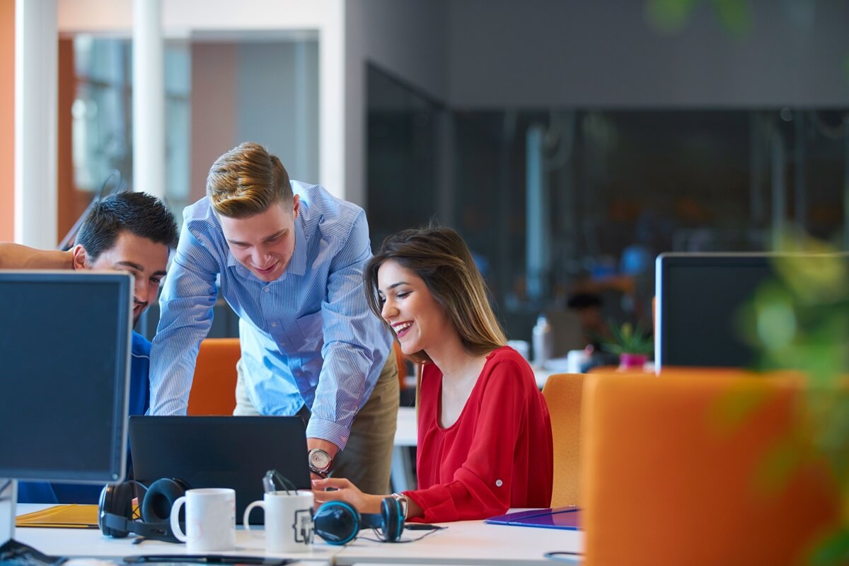 Employees working together at the office practicing emotional intelligence