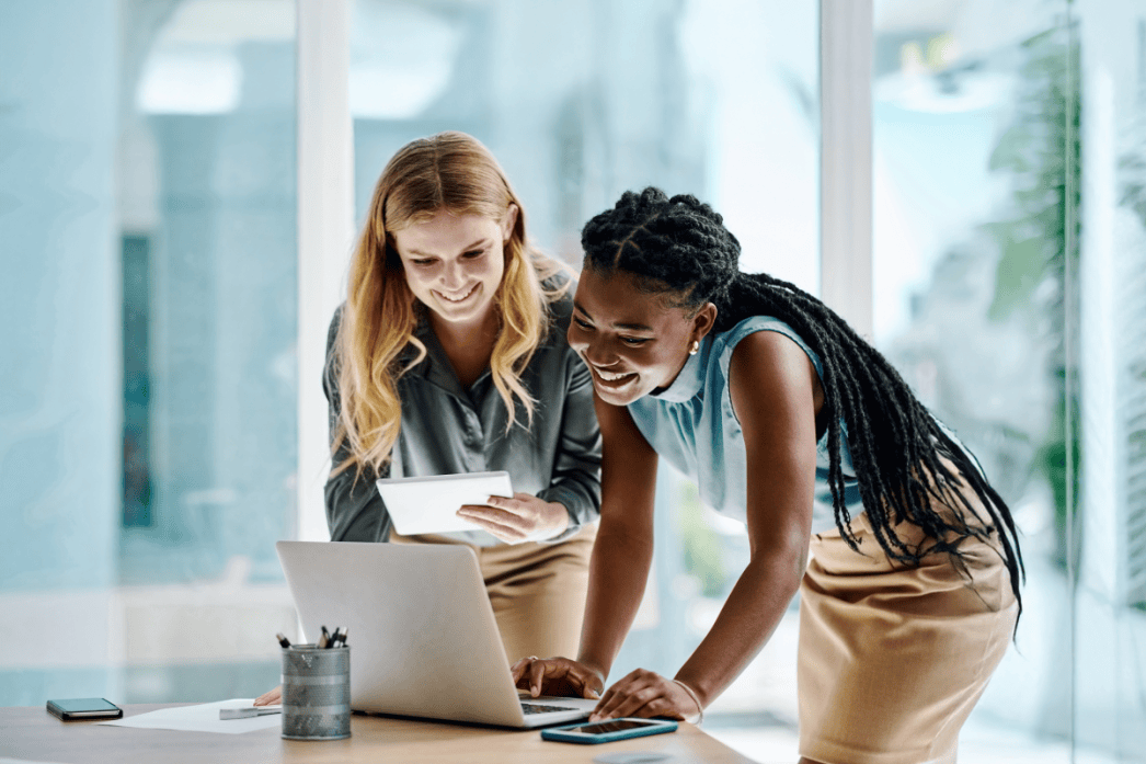 Two office professionals collaborating at a laptop