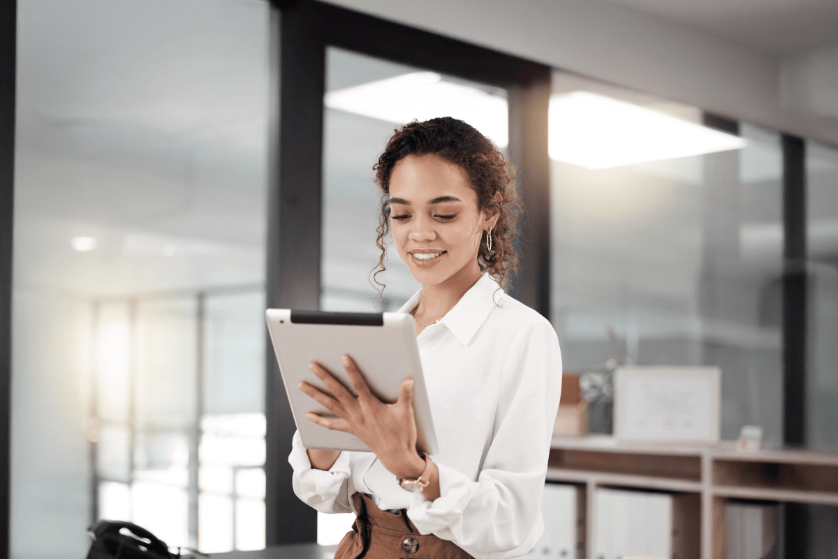 Professional woman using a tablet in a modern office setting