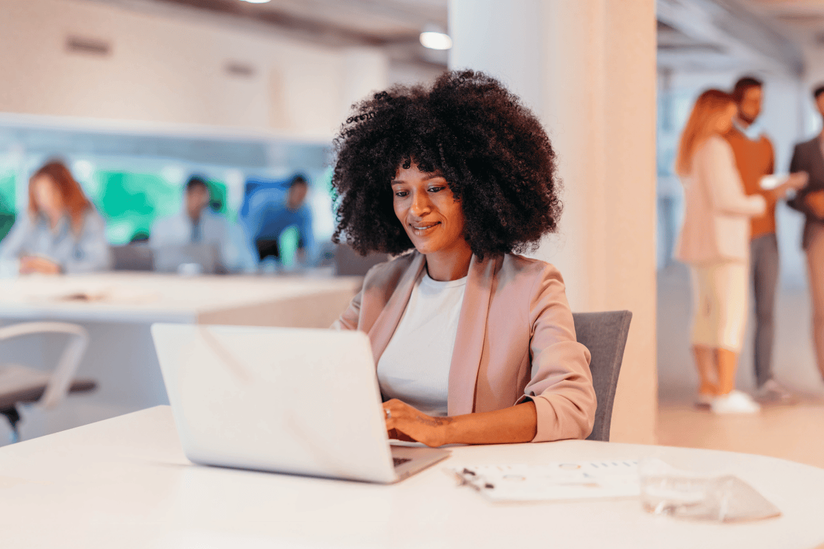 Professional reviewing data on laptop in modern office
